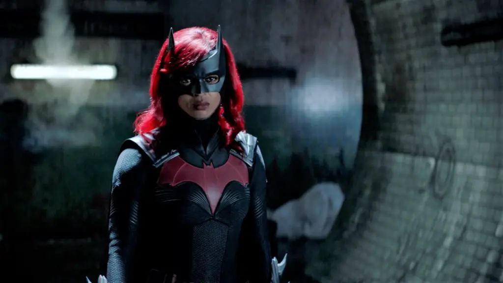 Woman with red hair an d batwoman mask on her face