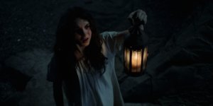 a girl standing wiht a lantern