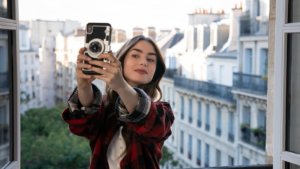 a girl taking a selfie; emily in paris season 3 release date