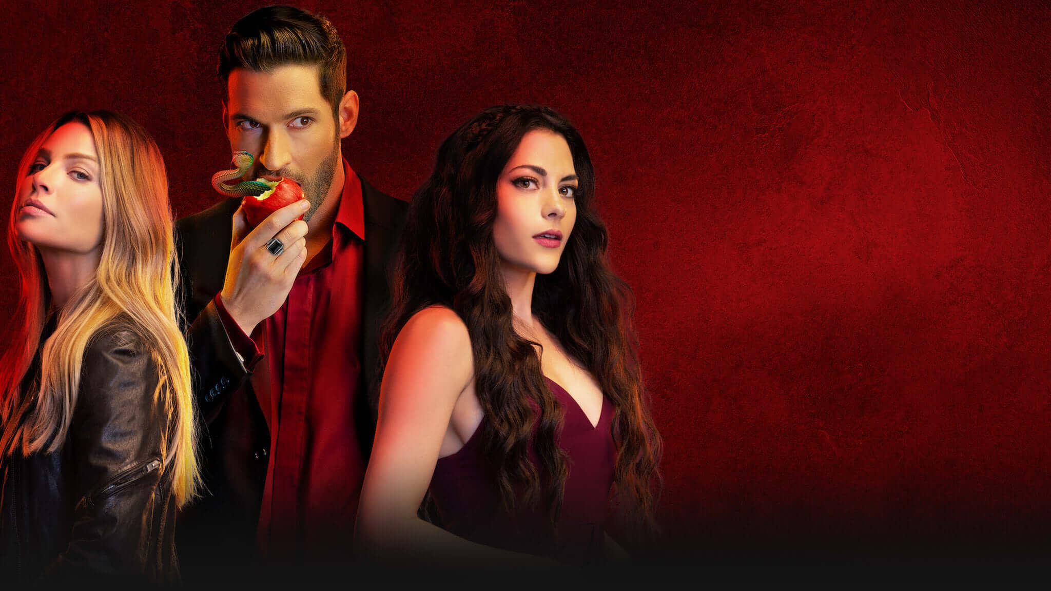 Lucifer is eating apple and standing with Chloe Decker and Maze.