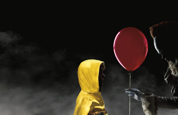 a scary man giving a child a balloon