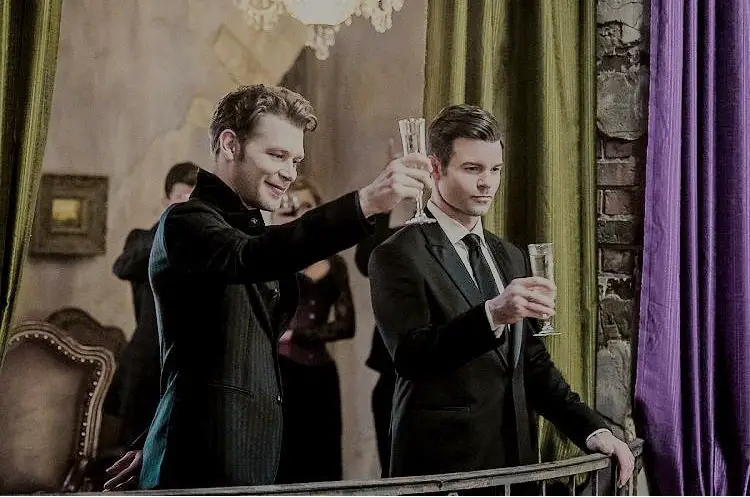 siblings Klaus and Elijah are raising a toast in an event.