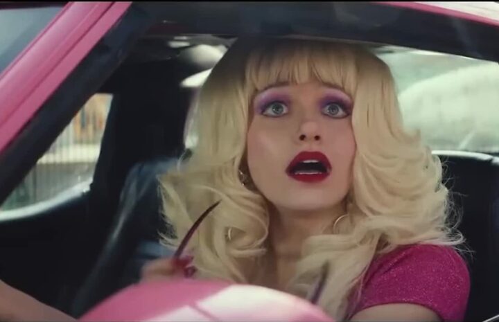 Angelyne is looking at someone from the car window