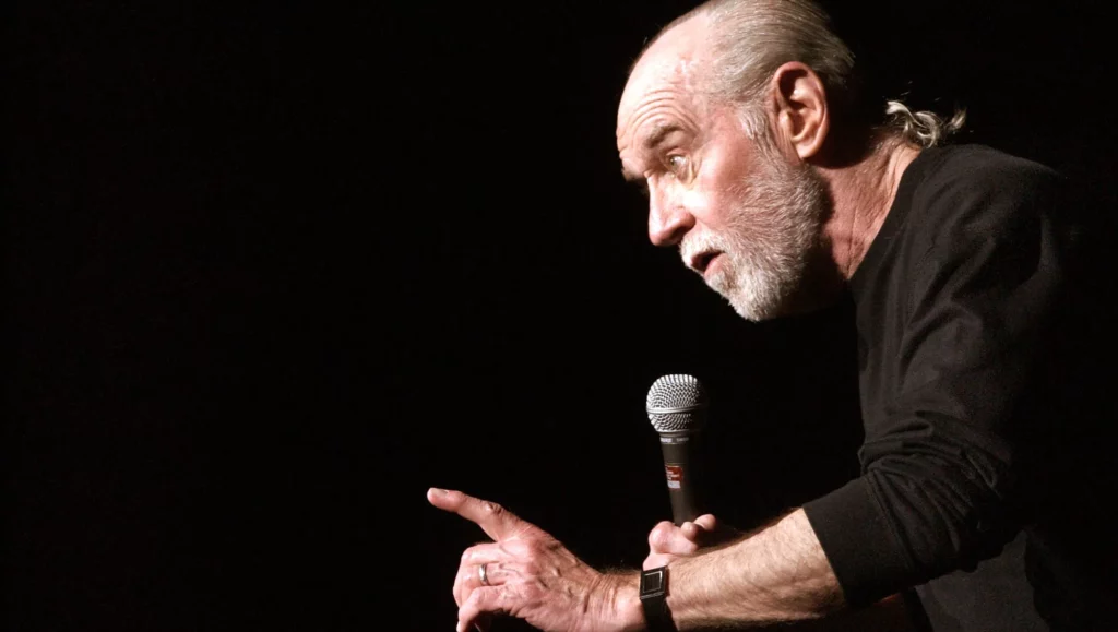 George Carlin is showing finger