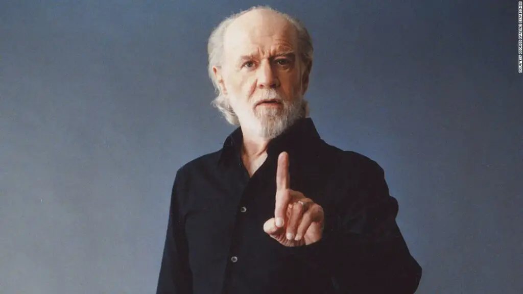 George Carlin is showing finger