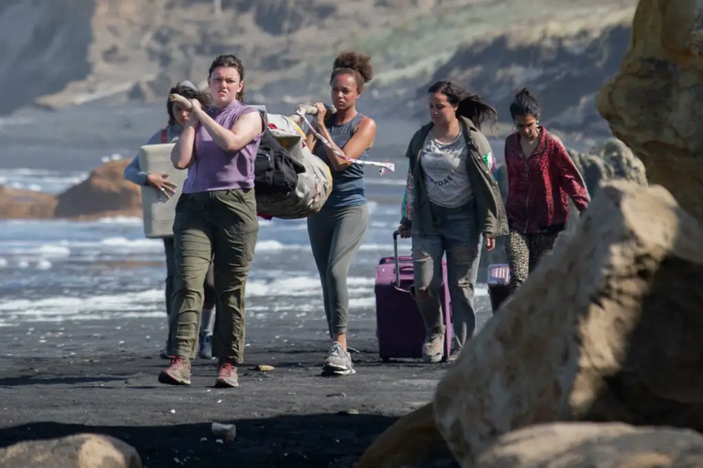 The group of teenage girls taking their luggage after plane crash