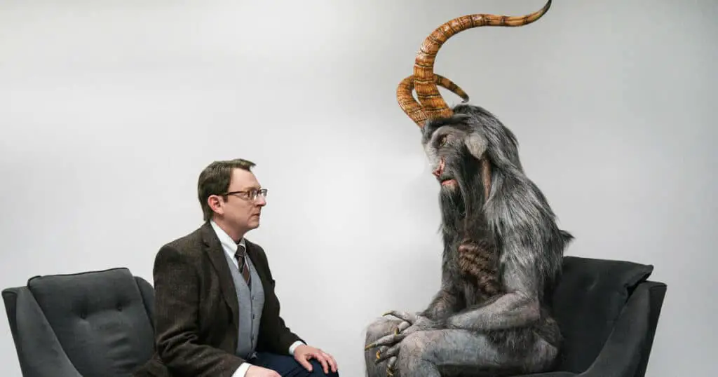 a man is talking to a strange creature